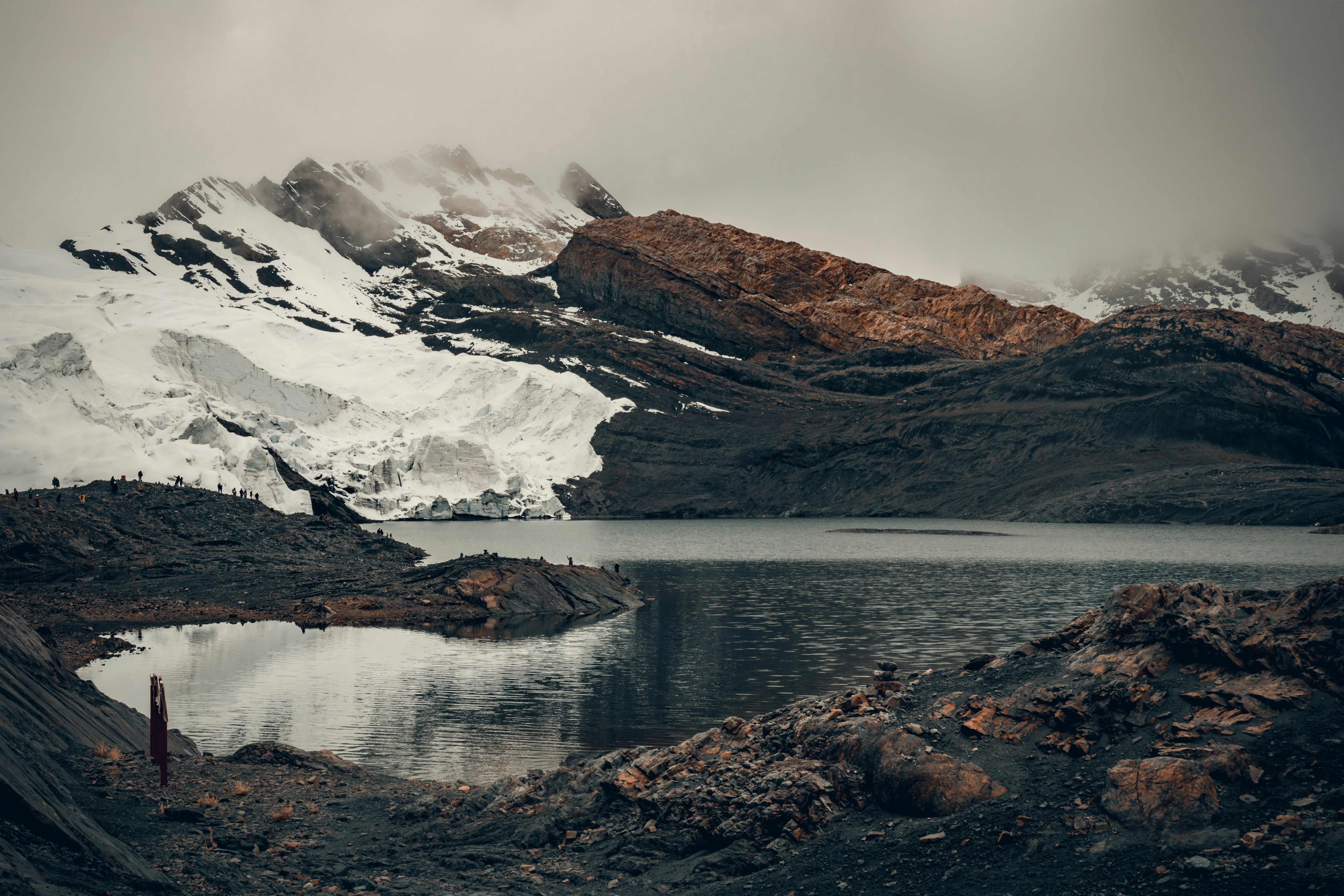 brown and white mountains near body of water during daytime